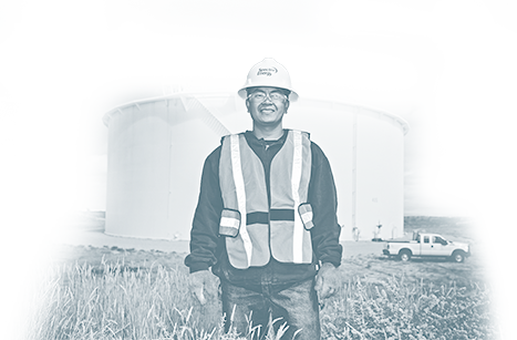 Spectra Energy Employee standing in front of a storage tank